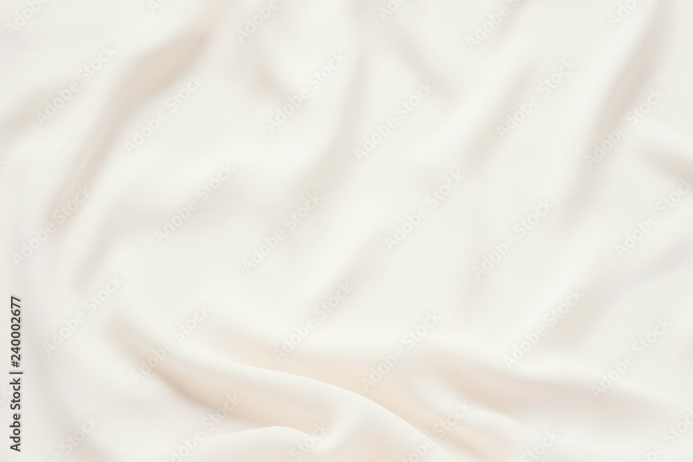 Matte cream delicate soft pleated fabric background. Smooth elegant luxury cloth texture. Gentle pastel color wedding background Matte cream delicate soft pleated fabric background. Smooth elegant luxury cloth texture. Gentle pastel color wedding background