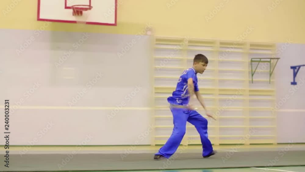 Young boy in traditional yifu chinese clothing for martial arts training wushu exercises. Boy