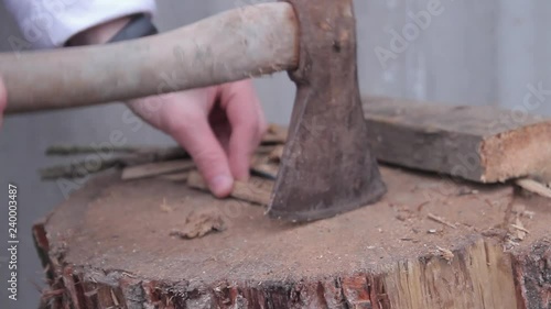 Wallpaper Mural The guy chops wood on the street in the winter evening.Close Up Torontodigital.ca