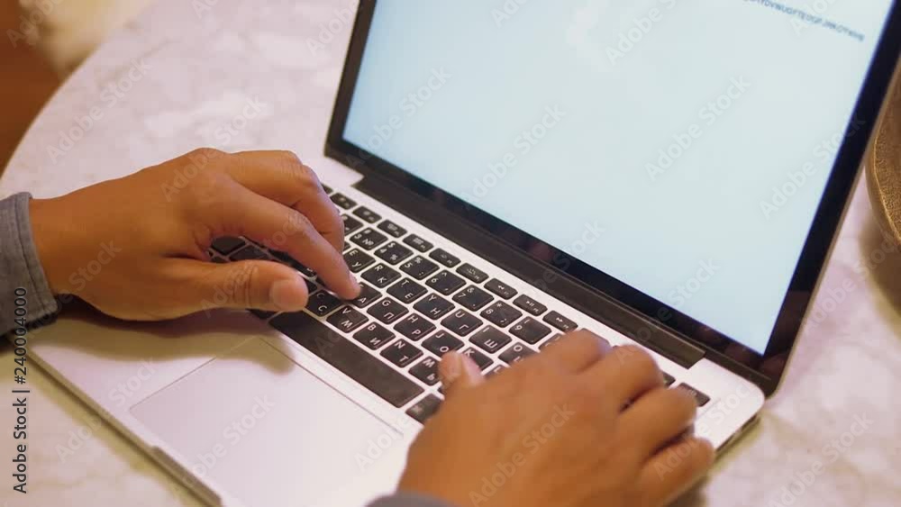 Male hands typing on keyboard of laptop. Close up shot of african american man working with laptop. Technology concept Male hands typing on keyboard of laptop. Close up shot of african american man working with laptop. Technology concept