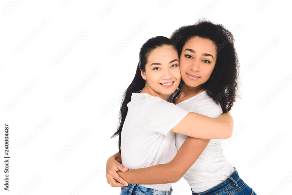 multicultural friends hugging and looking at camera isolated on white multicultural friends hugging and looking at camera isolated on white