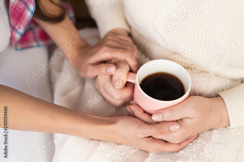 Holding cup of tea on knees