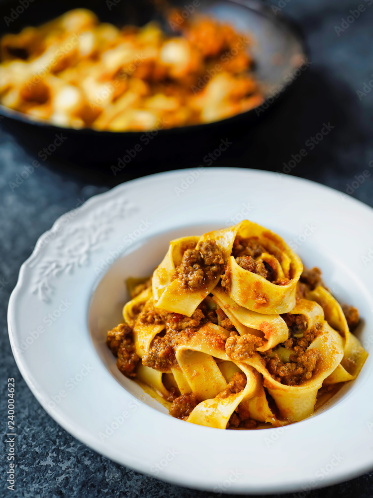 rustic italian pappardelle bolognese pasta in meat sauce