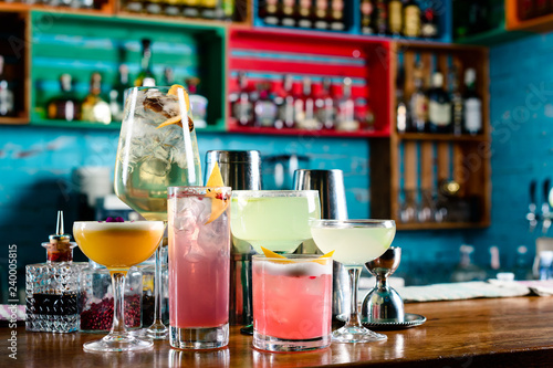set of Classic alcoholic cocktails on bar counter in pup or restaurant with copy space