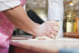 Closeup of woman hands of the Baker knead and mold the dough