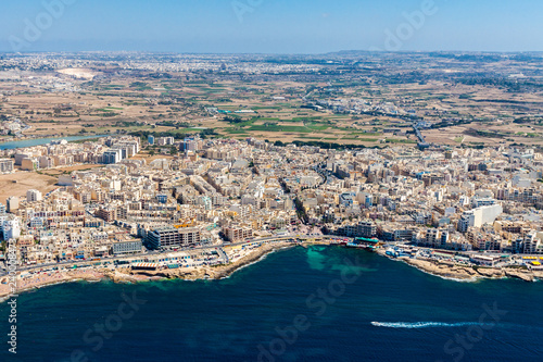 Aerial view of Bugibba town, St. Paul's Bay in the Northern Region, Malta. Popular tourist resort destination with promenade, hotels, restaurants, pubs, clubs, and a casino. © Dmitry