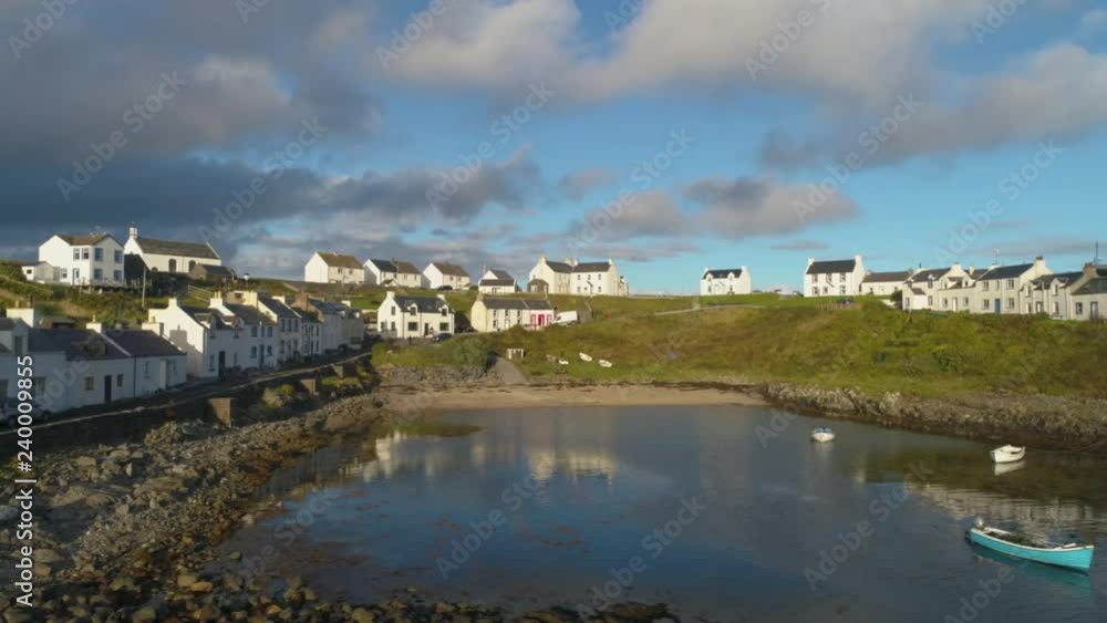 Cinematic Aerial Drone Shot in Scottish Highlands, moving slowly low over sea towards Portnahaven bay on the Isle of Islay Cinematic Aerial Drone Shot in Scottish Highlands, moving slowly low over sea towards Portnahaven bay on the Isle of Islay