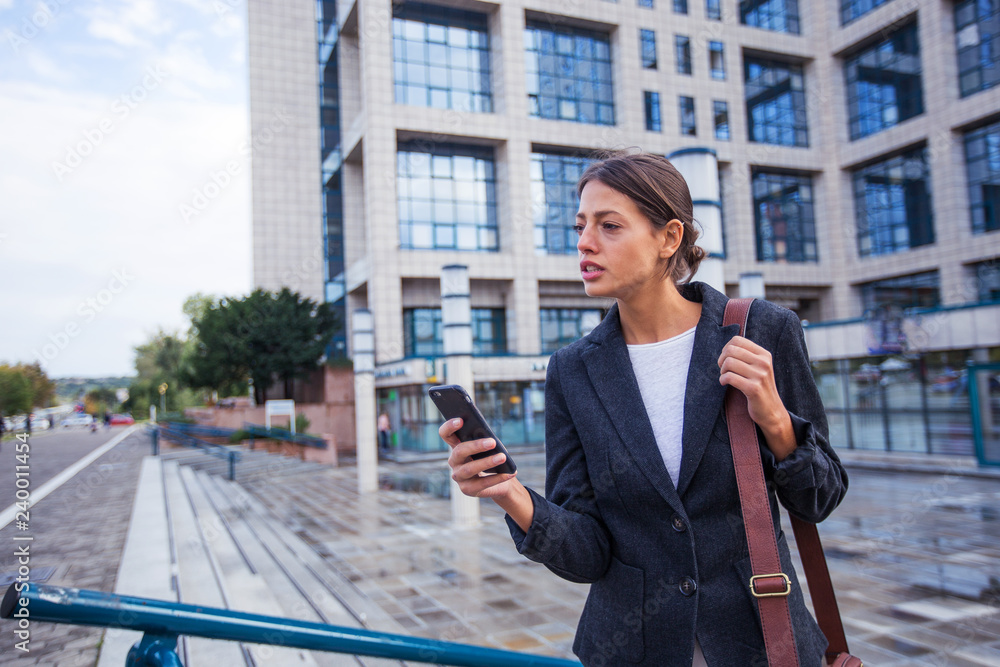Young businesswomen in black suit using smart phone Young businesswomen in black suit using smart phone