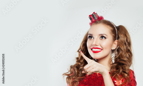 Happy young girl pointing. Cheerful woman with cute smile and funny face