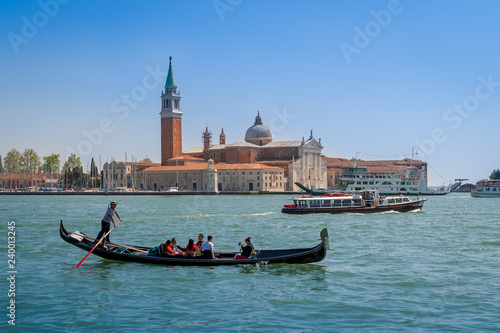 Gondola boat and San Giorgio popular touristic island in Venice