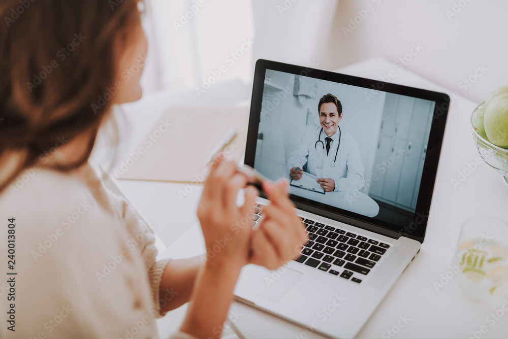 Cheerful doctor making video-call to his patient at home Cheerful doctor making video-call to his patient at home