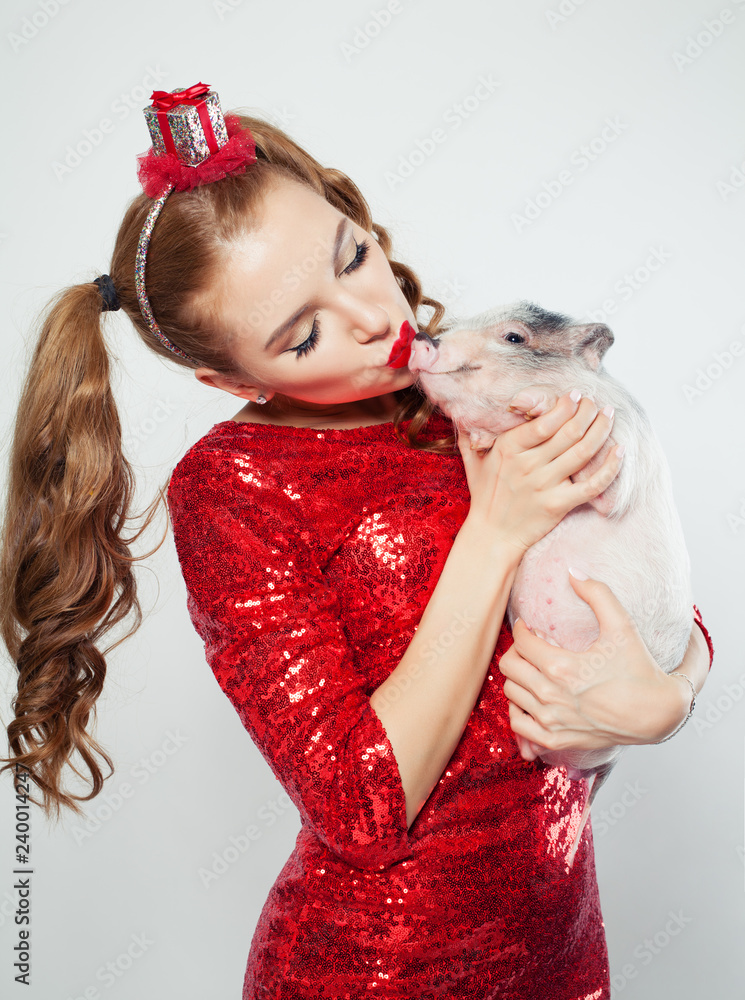 Pretty woman kissing mini pig pet on white background Pretty woman kissing mini pig pet on white background