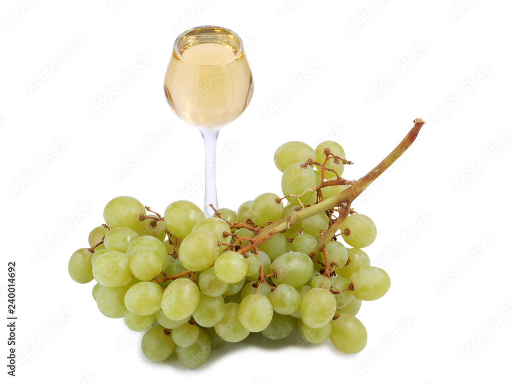 Glass of wine and green grapes on white background
