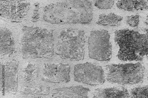 Texture of vintage old weathered wall of house outside. Abstract background. Horizontal black and white photography.