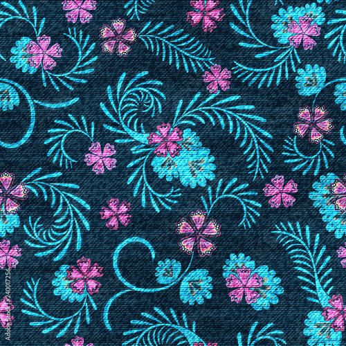 Floral seamless pattern. Colorful flowers on the dark backdrop. The effect of embroidery on denim