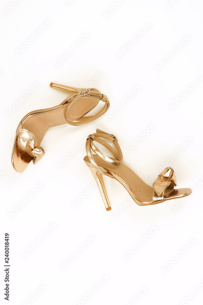 women high heel shoes sandals gold color on white background. Flat lay, top  view trendy fashion beauty female background. High heels background  Stock-Foto | Adobe Stock
