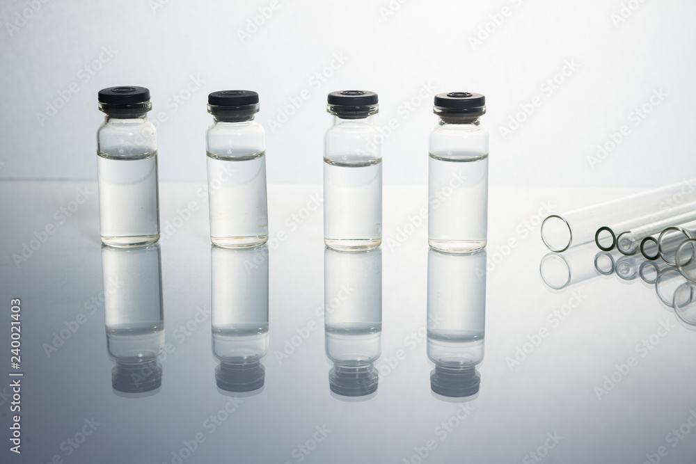 Group of vials with medication on blue methacrylate table. Group of vials with medication on blue methacrylate table.