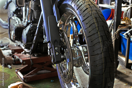 Cropped close up shot of beautiful and custom made motorcycle in the workshop © Georgii