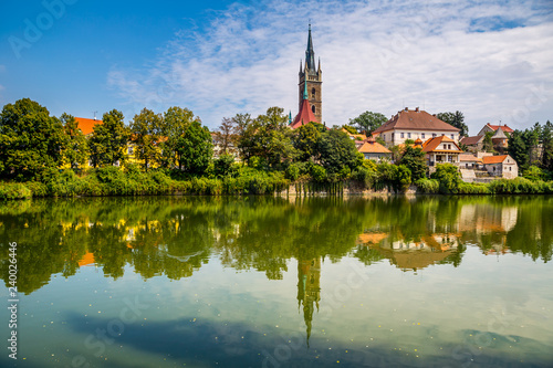 Reflection of church tower on the surface of the pond © Pavel Rezac
