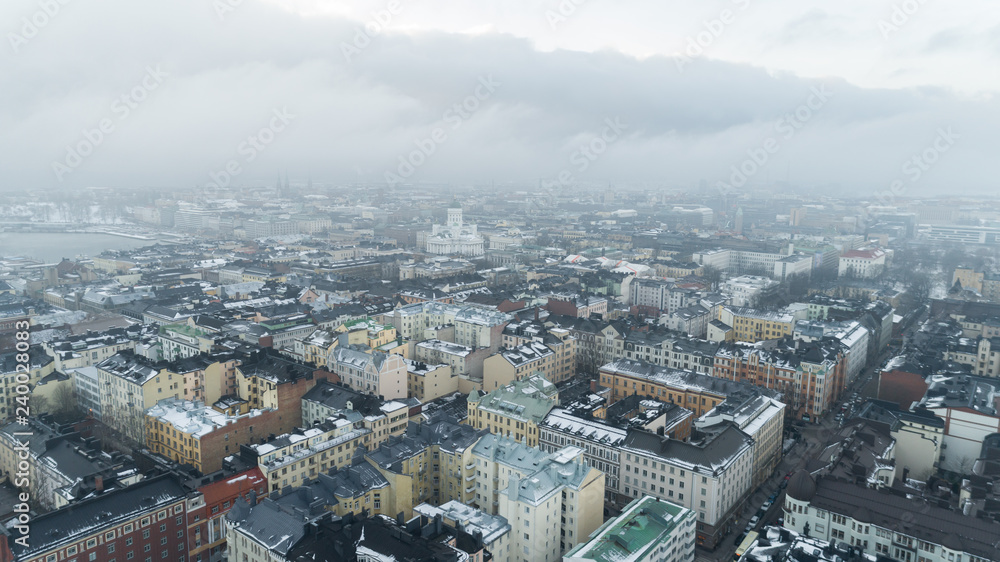 Aerial winter panorama of Helsinki, Finland. Dark snow clouds over the city