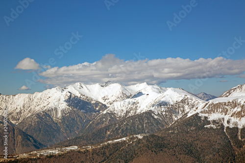 snowy mountain peaks against the blue sky © Georgii