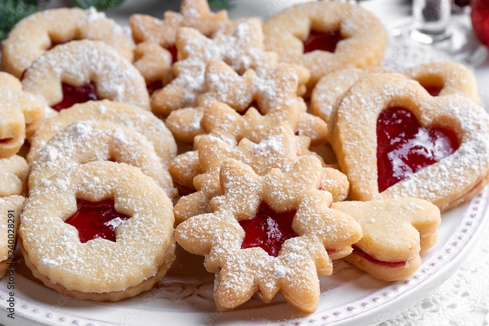 Traditional Linzer Christmas cookies filled with strawberry jam
