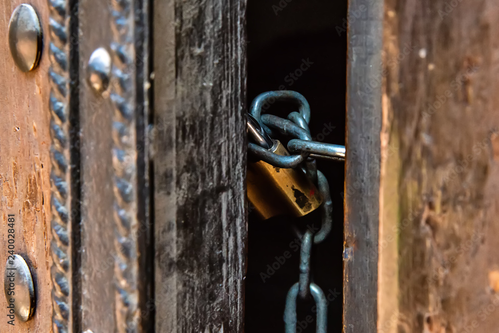 Closed door by chain and padlock Closed door by chain and padlock