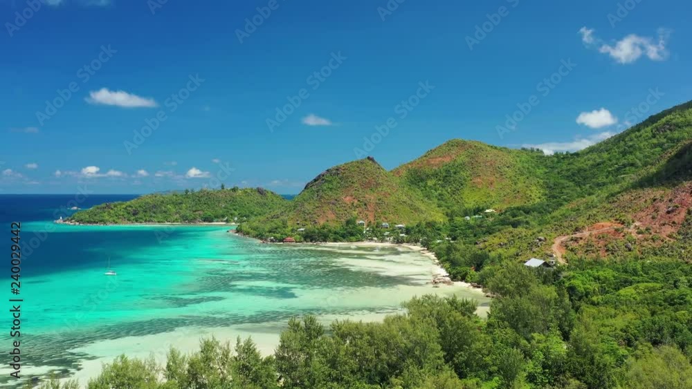 Aerial view of tropical paradise beach with white sand and turquoise crystal clear waters of Indian Ocean - Anse Possession, Praslin Island, Seychelles Aerial view of tropical paradise beach with white sand and turquoise crystal clear waters of Indian Ocean - Anse Possession, Praslin Island, Seychelles
