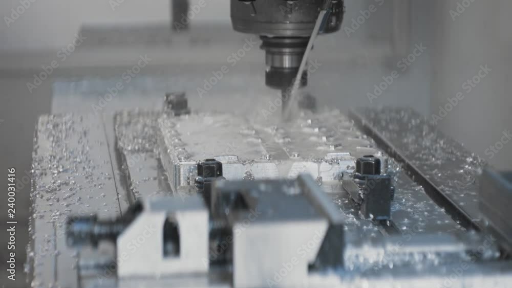 Cnc metal working machine with cutter tool luminium detail milling at factory. Tech process of metalwork and machine manufacturing of press form close up. Precision milling work. Slowmotion, closeup Cnc metal working machine with cutter tool luminium detail milling at factory. Tech process of metalwork and machine manufacturing of press form close up. Precision milling work. Slowmotion, closeup