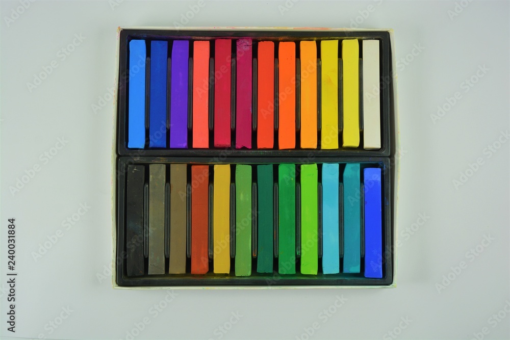 Pastel crayons in a box on a white background Pastel crayons in a box on a white background