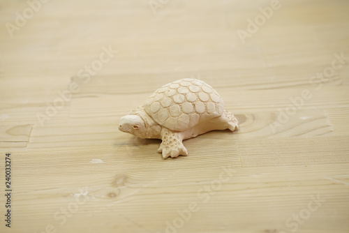 beautiful handmade turtle from raw clay on the table 