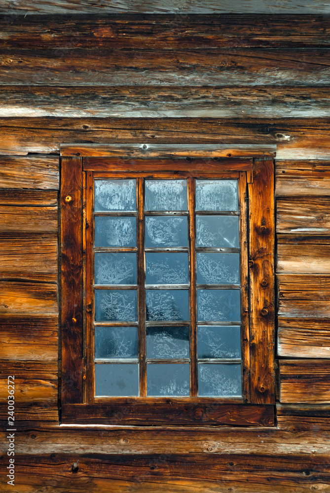 window in the log wall of an old building window in the log wall of an old building