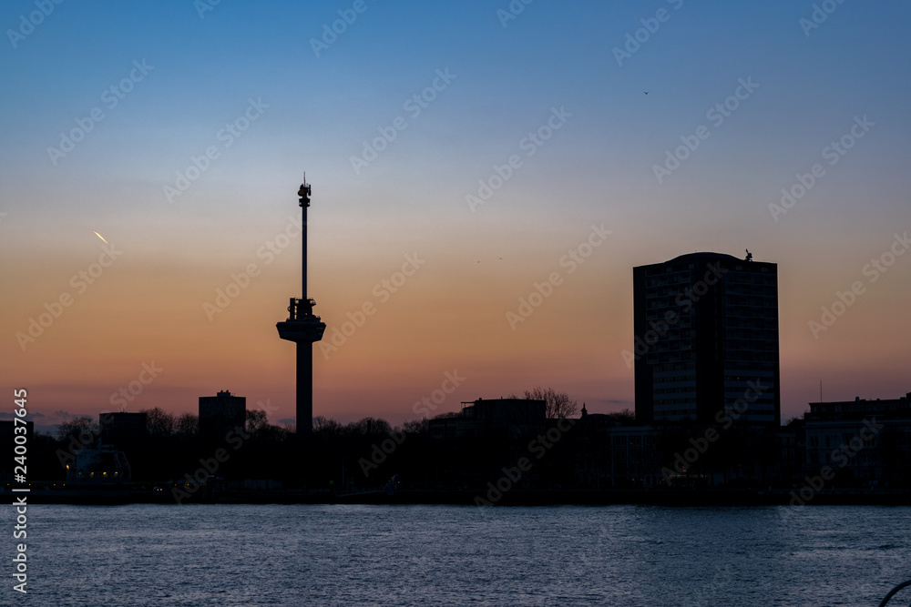 Silhouette of the skyline of Rotterdam at sunset. The mast is an observation tower called Silhouette of the skyline of Rotterdam at sunset. The mast is an observation tower called