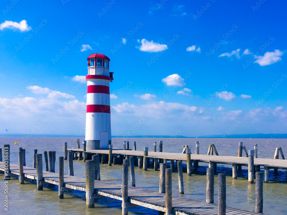 Lighthouse on the lake on a sunny summer day Lighthouse on the lake on a sunny summer day