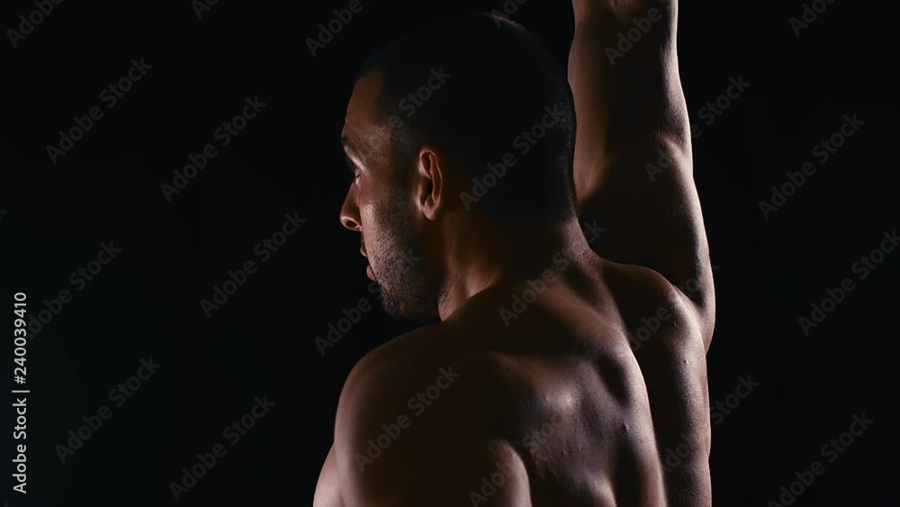 Lifting dumbbells for bigger biceps close up. Close up handsome man with big biceps lifting weigths over dark background. 4k slow motion Lifting dumbbells for bigger biceps close up. Close up handsome man with big biceps lifting weigths over dark background. 4k slow motion