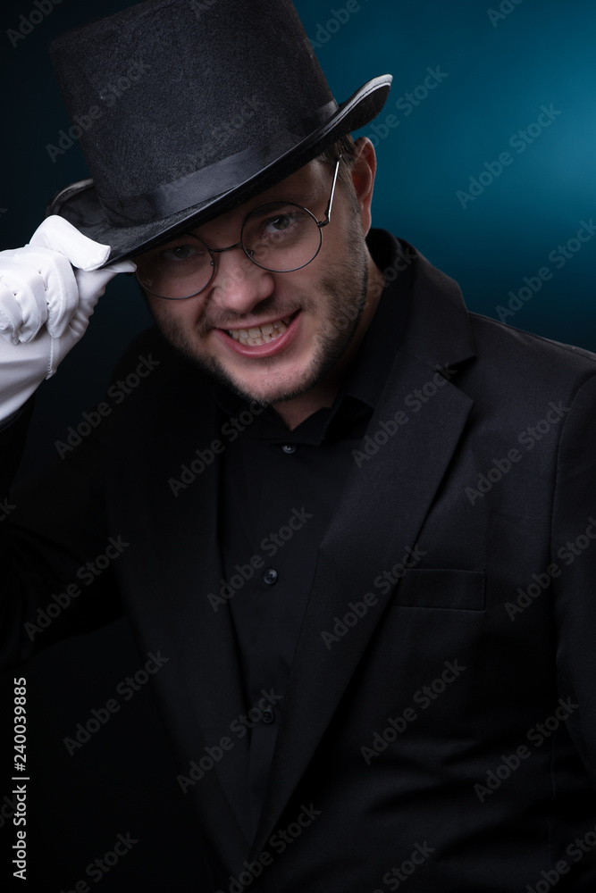 Image of happy man in black hat in white gloves