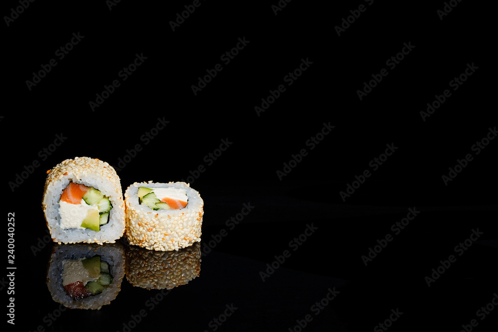 a photograph of sushi and roles on the black mirror background a photograph of sushi and roles on the black mirror background