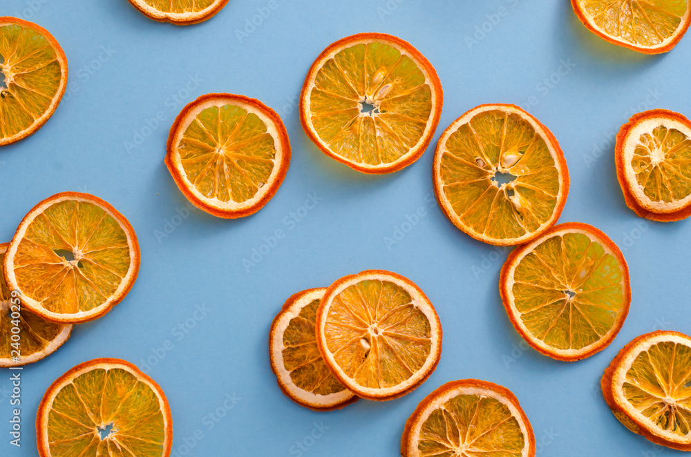 Dried slices oranges citrus fruit on light blue background. Homemade natural aroma decor. Concept of holiday. Marry Christmas. Close up, flat lay, top view Dried slices oranges citrus fruit on light blue background. Homemade natural aroma decor. Concept of holiday. Marry Christmas. Close up, flat lay, top view