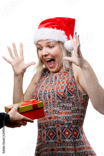 Image of joyful woman in Santa's cap and man's hands with gift © Sergey