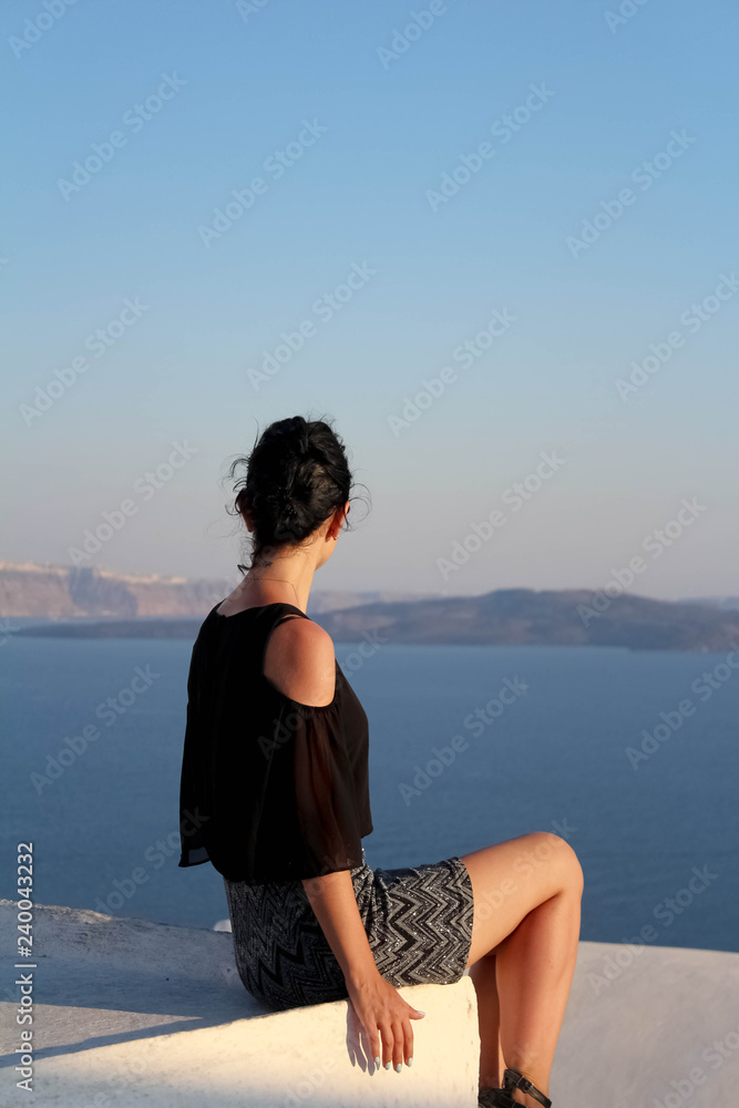 Young girl sitting with ther back turned to camera Young girl sitting with ther back turned to camera