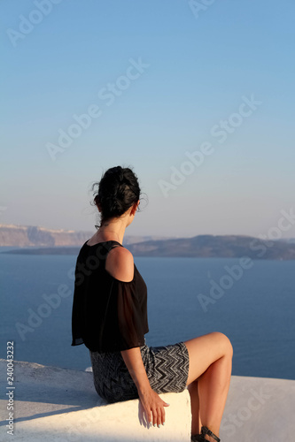 Fotografija Young girl sitting with ther back turned to camera