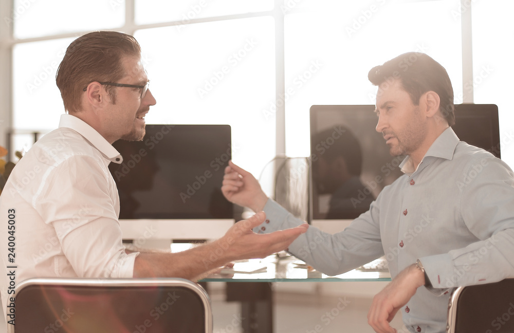 rear view.two employees discussing new ideas. rear view.two employees discussing new ideas.