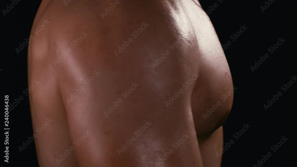 Lifting dumbbells for bigger biceps over dark background. Close up handsome man feeling pain in his arm. 4k Lifting dumbbells for bigger biceps over dark background. Close up handsome man feeling pain in his arm. 4k
