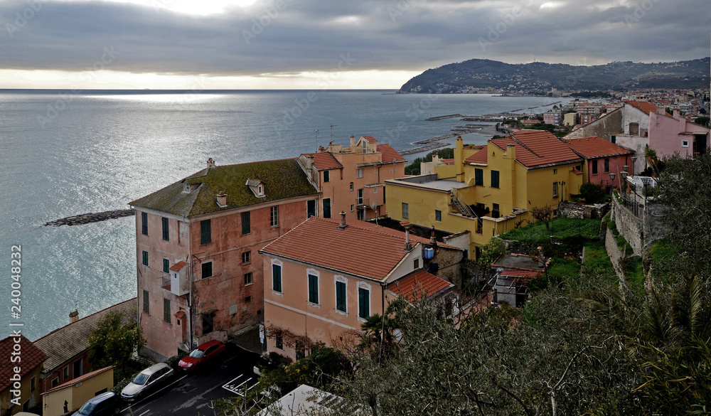 Liguria, Italy, landscape of Cervo town in winter. Mountain and mediterranean sea in the background