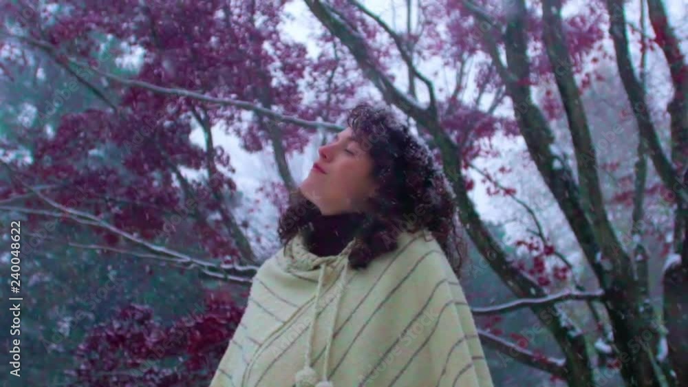Young pretty woman meditates as she stands outside in first snow of winter Young pretty woman meditates as she stands outside in first snow of winter