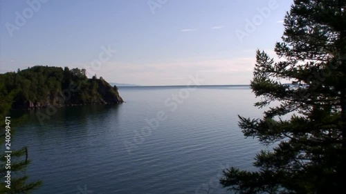 Green trees of taiga on rocky coastline of deepest freshwater lake Baikal. photo