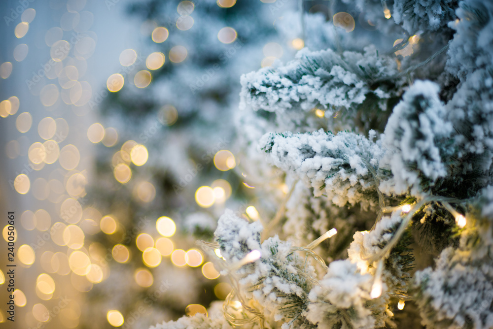 Christmas tree closeup, light bulbs, blurred background