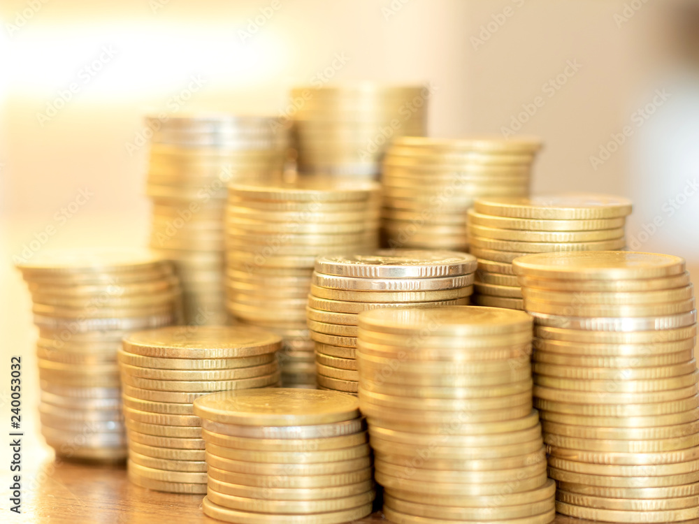 Invest your money to get in come,growing business and future concept, coins stack on wooden table Invest your money to get in come,growing business and future concept, coins stack on wooden table