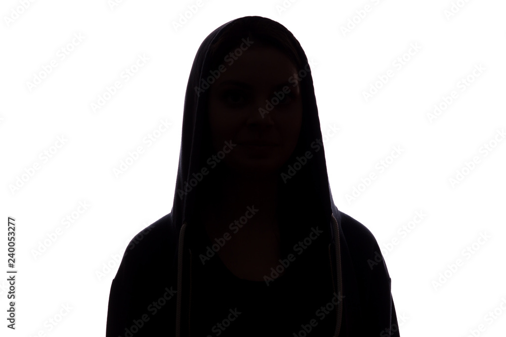 Silhouette of a girl in the hood, the symbol of anonymity Silhouette of a girl in the hood, the symbol of anonymity