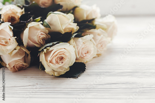 White roses on wooden background  space for text. Floral greeting card mockup. Wedding invitation or happy mother day concept. Bouquet of white flowers. hello spring